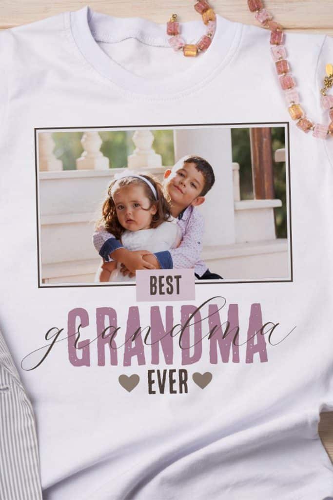 White T-Shirt Featuring “Best Grandma Ever” Text In Pink And Brown With A Centered Photo Of Grandkids And Two Heart Icons—Personalized Mother’s Day Gift.