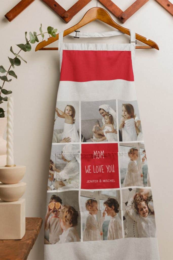 Apron With Bold Red Accent, “We Love You Mom” Text, And A Collage Of Family Photos—Displayed Hanging In A Cozy Home Setting, Perfect Mother’s Day Gift.