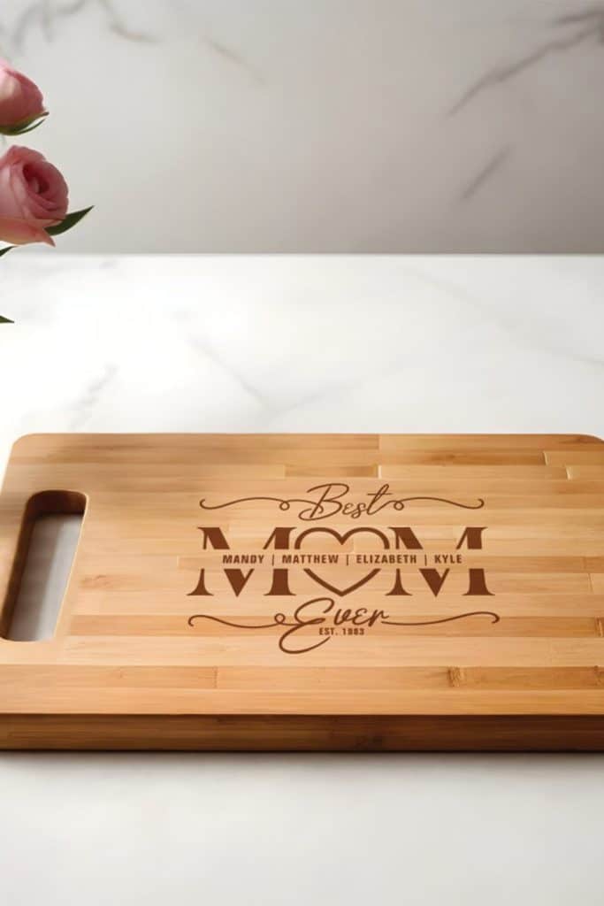 Bamboo Cutting Board Engraved With “Best Mom Ever,” Featuring Family Names And An Established Year, Styled On A Marble Kitchen Counter.