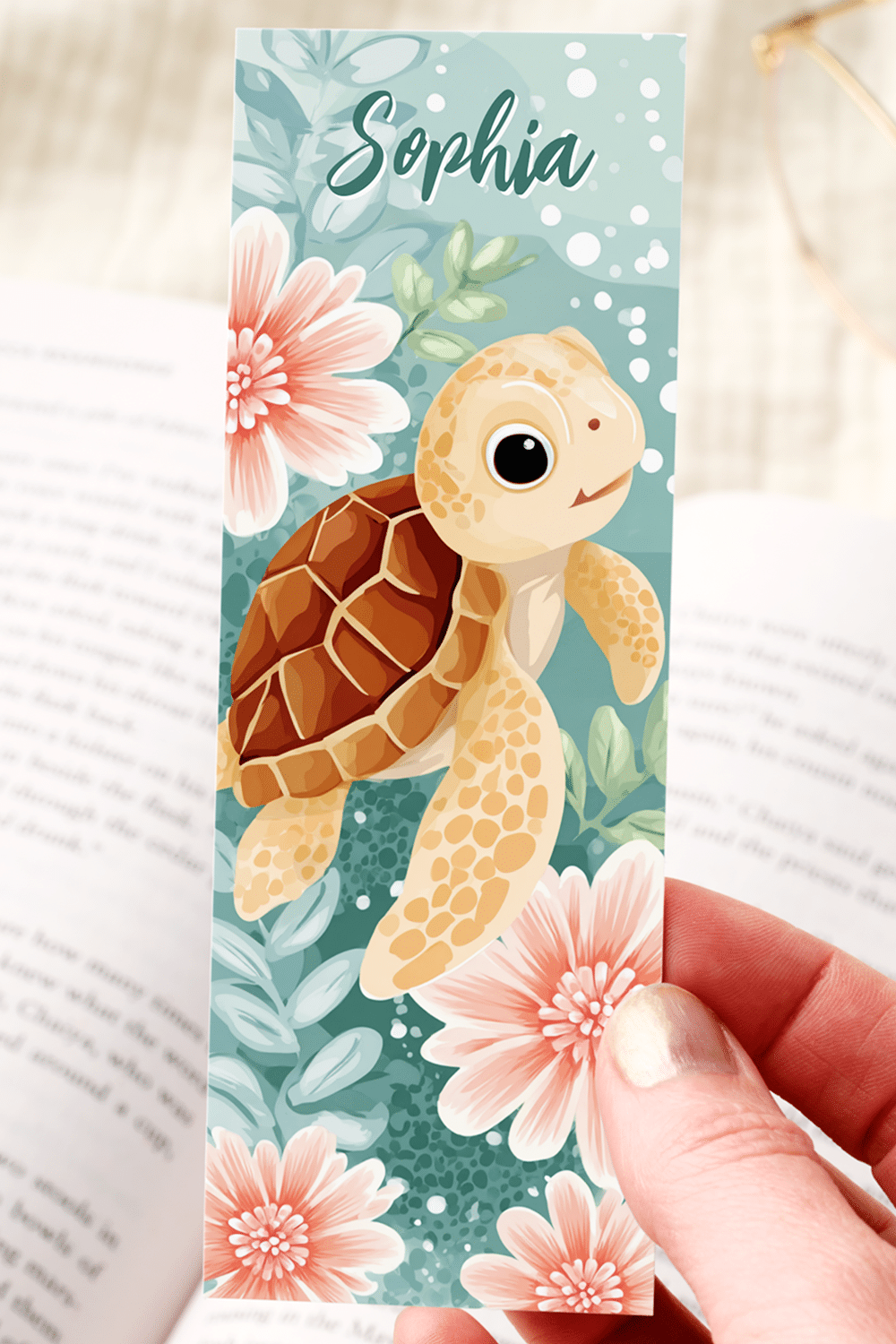 Cute Kawaii Bookmark Featuring A Sweet Baby Sea Turtle Swimming Amidst Coral Pink Flowers And Leafy Sea Greens In A Watercolor-Inspired Underwater Scene.
