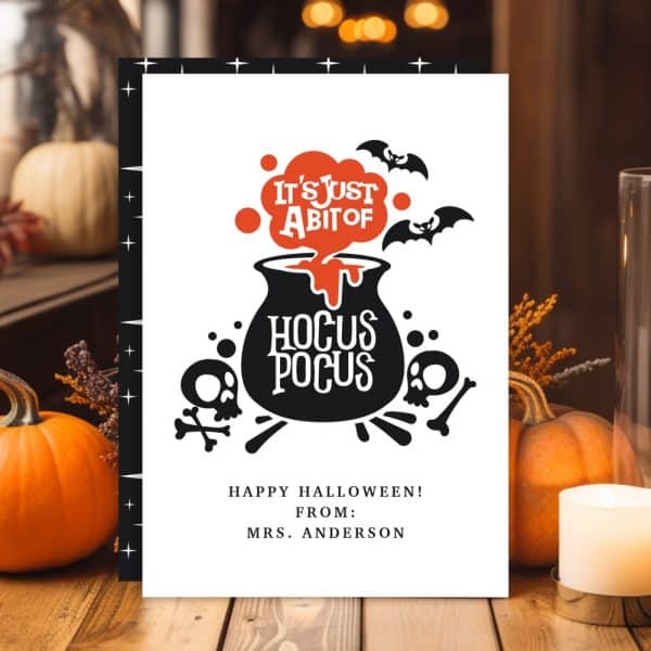 Halloween Card Featuring A Cauldron With &Quot;Hocus Pocus&Quot; And Bats.