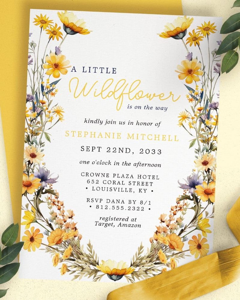 A baby shower invitation for Stephanie Mitchell featuring a floral wreath border.