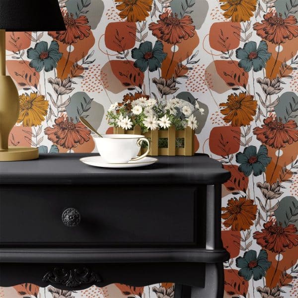 Black Dresser With Teacup And Saucer On Top, Set Against A Floral Wallpaper Featuring Orange, Teal, And Gray Flowers.