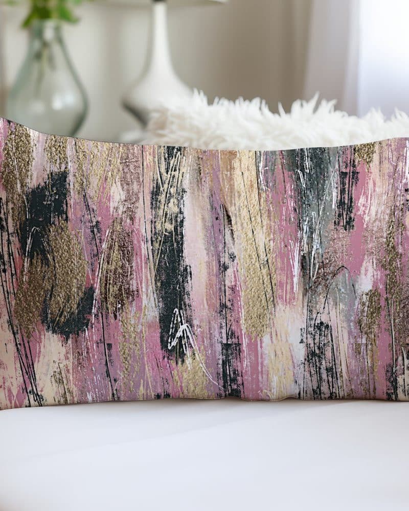 Rectangular pillow with abstract pink, gold, and black brushstrokes.