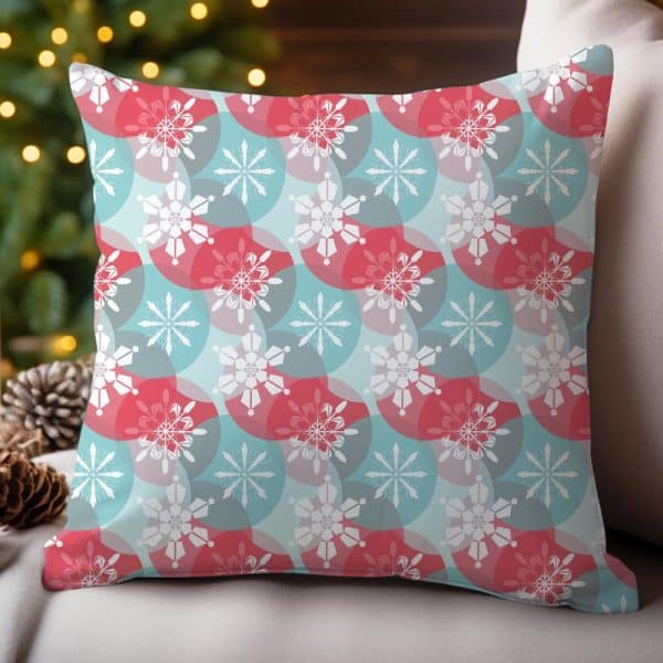 Decorative Throw Pillow With A Repeating Snowflake Pattern In Red And Teal.