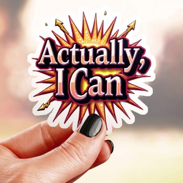 Hand Holding A Sticker That Says Actually, I Can In Stylized Text On A Sunburst.