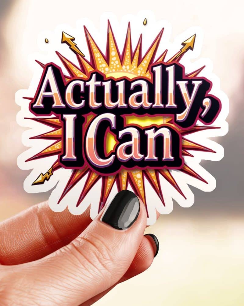 Hand holding a sticker that says Actually, I Can in stylized text on a sunburst.
