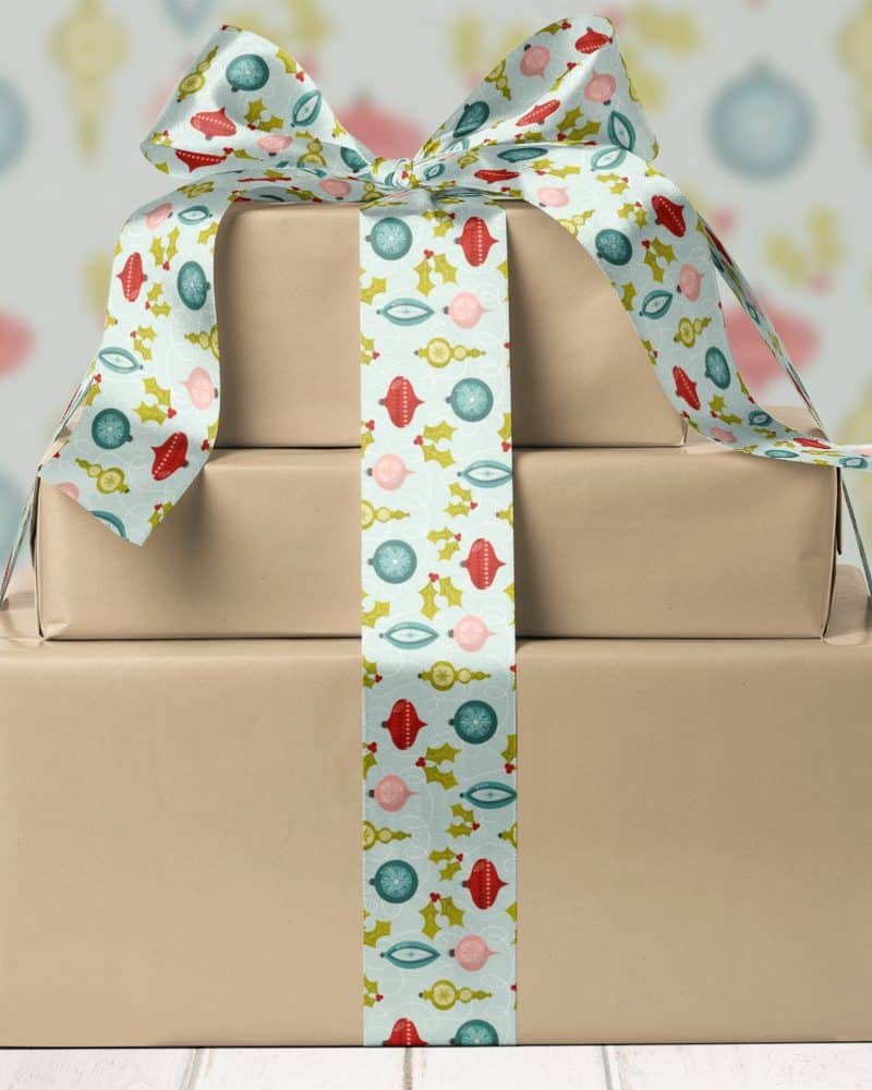 A stack of three brown gift boxes tied with a festive ribbon.
