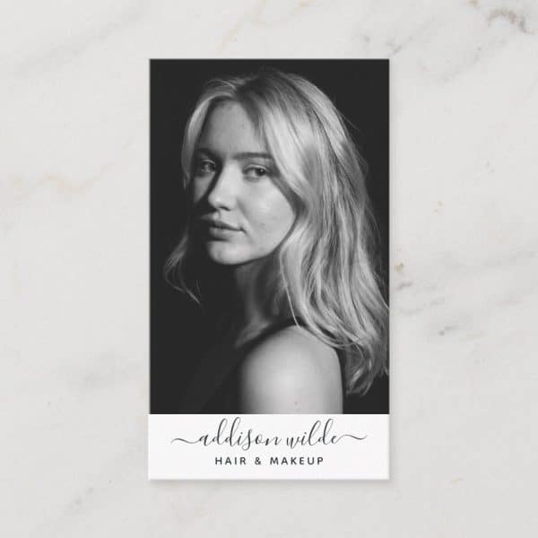 Black And White Photo Of A Woman With Long Blonde Hair, Looking Over Her Shoulder. Below The Photo, Text Reads Addison Wilde Hair &Amp; Makeup.