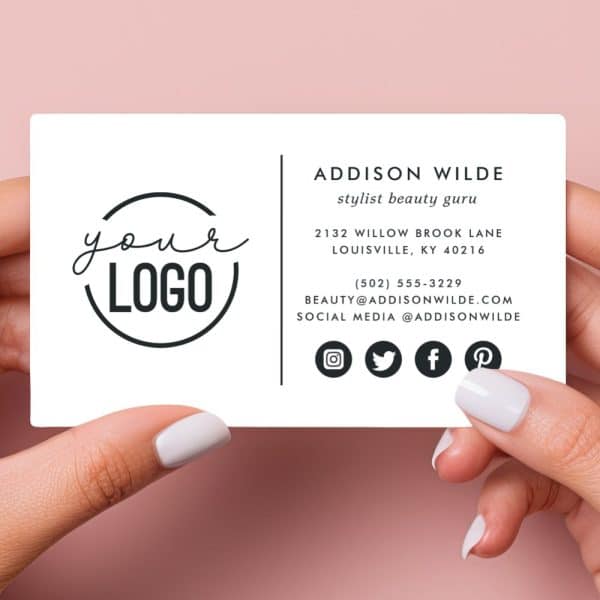 A White Business Card Held Between Two Fingers, Featuring A Circular Logo Placeholder That Says &Quot;Your Logo,&Quot; And Contact Information For Addison Wilde, Stylist And Beauty Guru.