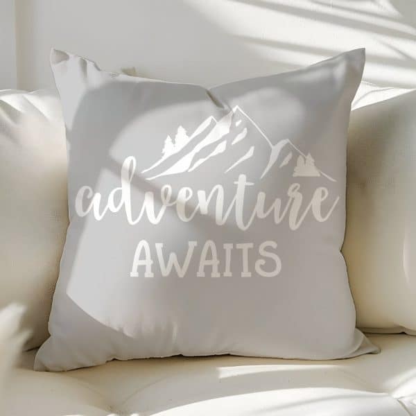 Light Gray Throw Pillow With White Mountain Graphic And The Text Adventure Awaits.