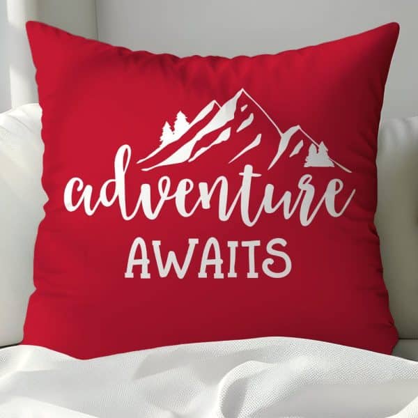Red Throw Pillow With White Mountain Graphic And The Text Adventure Awaits.