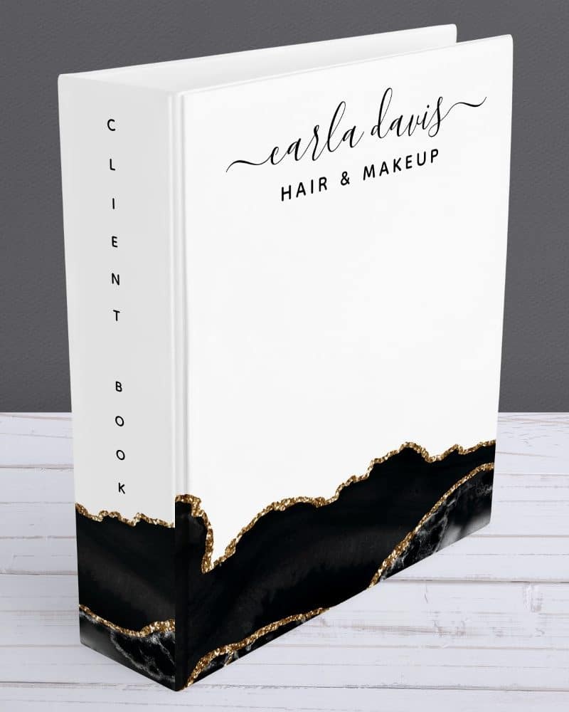 White client book with black and gold design, titled Carla Davis Hair & Makeup.