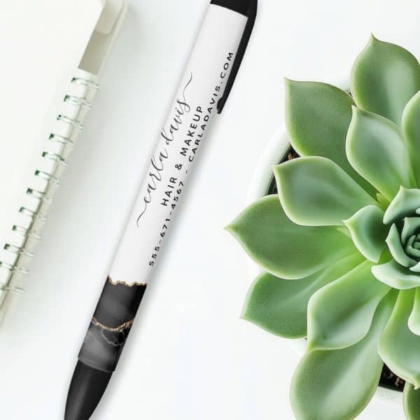 A Pen With Carla Davis Hair &Amp; Makeup Contact Information And A Black And Gold Marble Design.