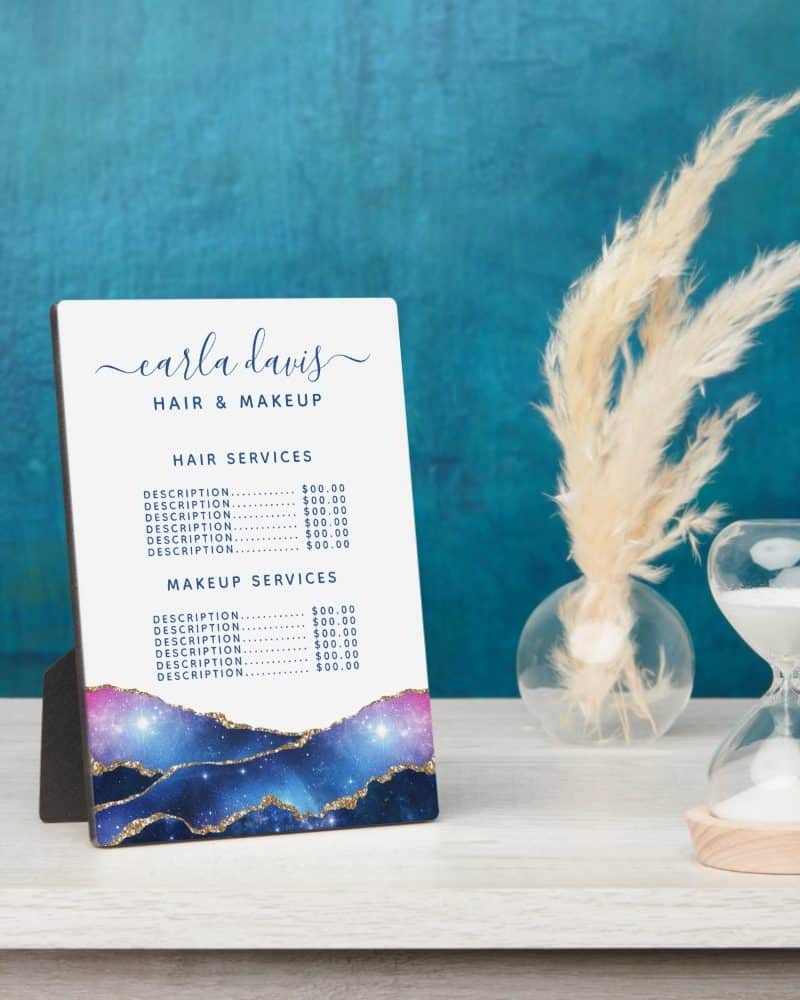 A freestanding price list for Carla Davis Hair & Makeup, featuring a galaxy-themed design.
