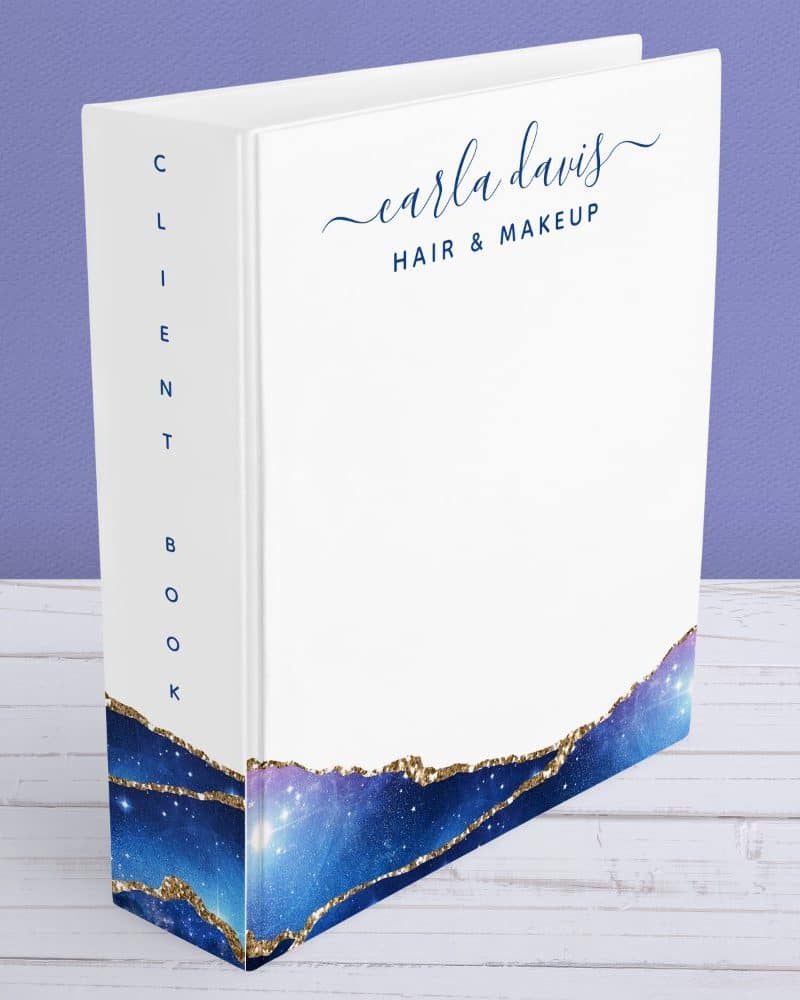 White client book with Carla Davis Hair & Makeup on the cover and a galaxy design on the spine.