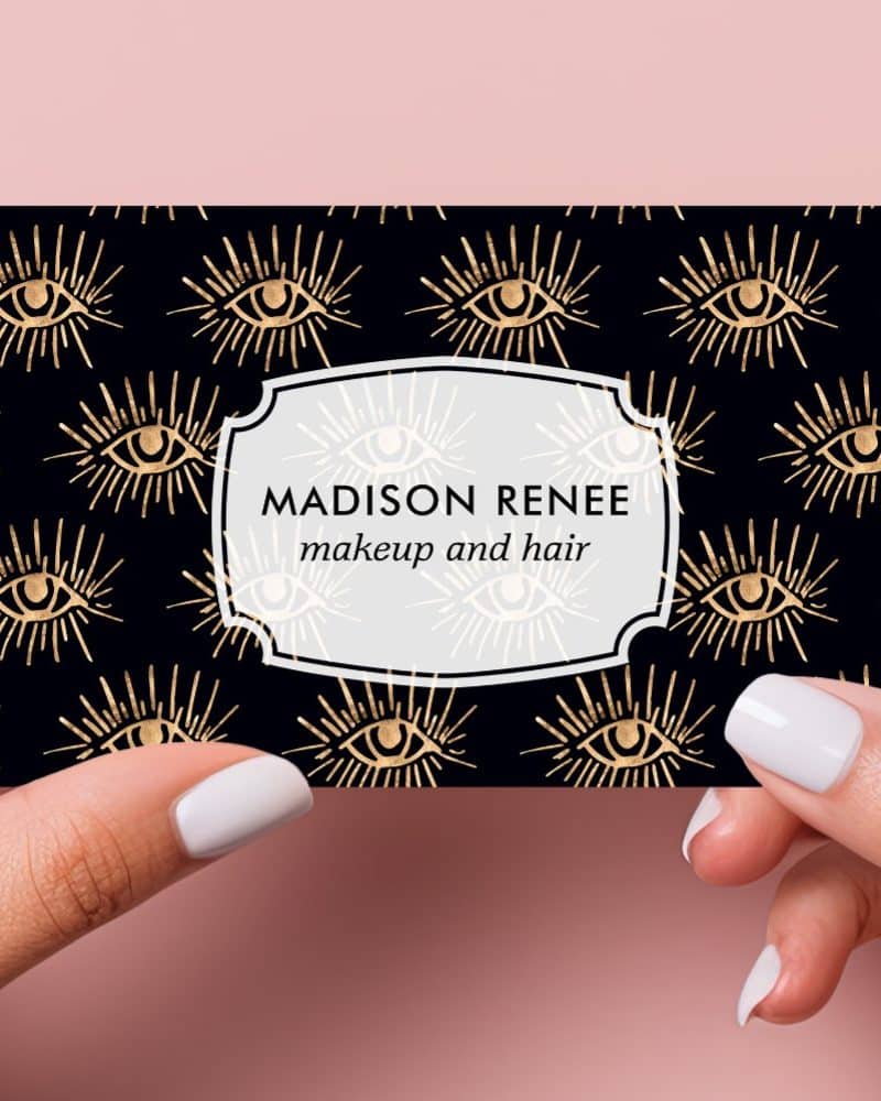 Business card with a black background and gold eye pattern; Madison Renee makeup and hair.