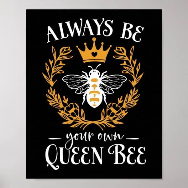 A Queen Bee Wearing A Crown Sits Within A Floral Wreath. Text Above Reads Always Be And Below Reads Your Own Queen Bee.