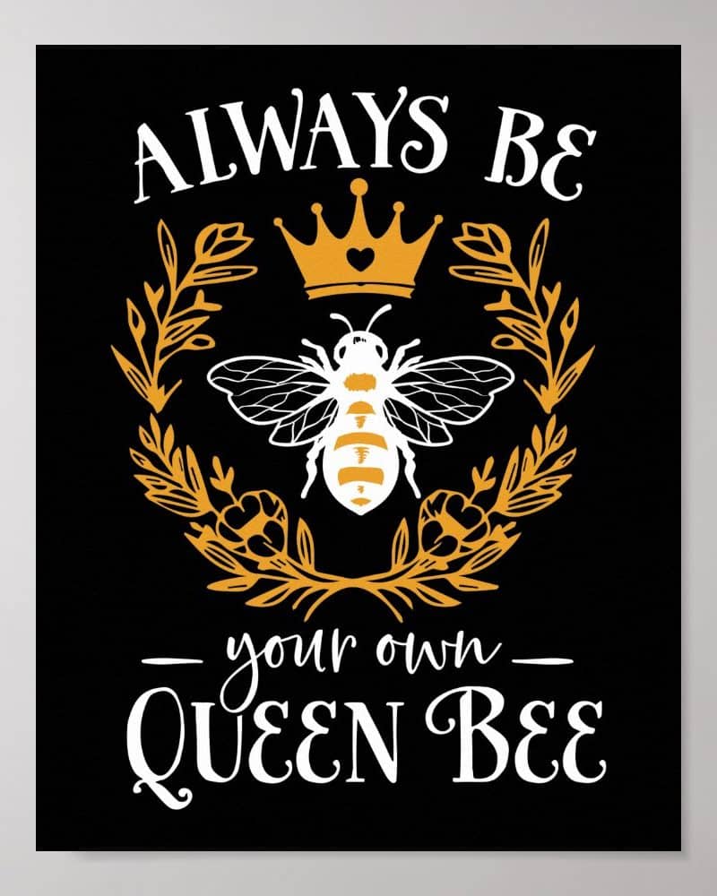 A queen bee wearing a crown sits within a floral wreath. Text above reads Always Be and below reads your own Queen Bee.