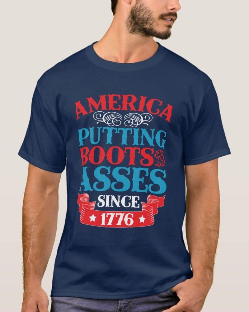 Navy blue t-shirt with the text America Putting Boots to Asses Since 1776 in red, white, and blue.