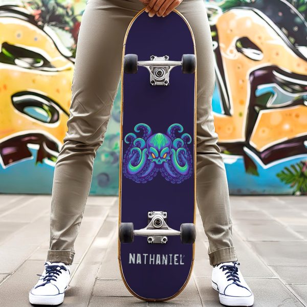 Person Holding A Skateboard With A Purple Octopus Skull Graphic.