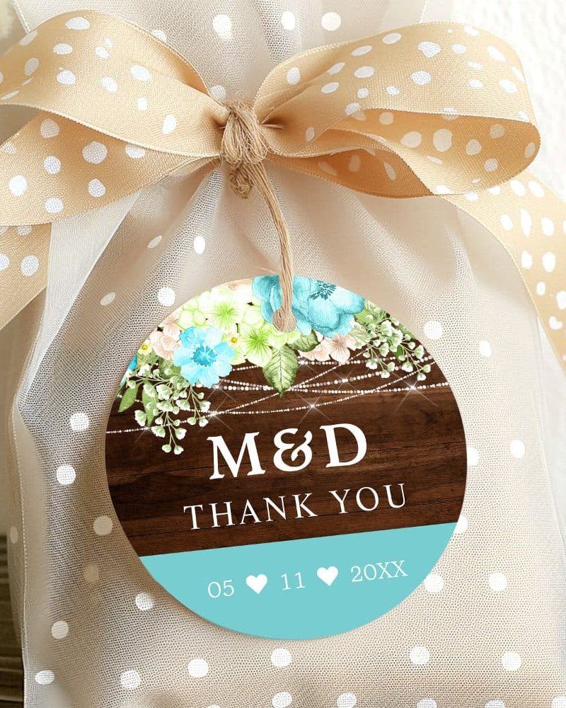Round wedding favor tag with floral design, initials M&D, thank you message, and wedding date.