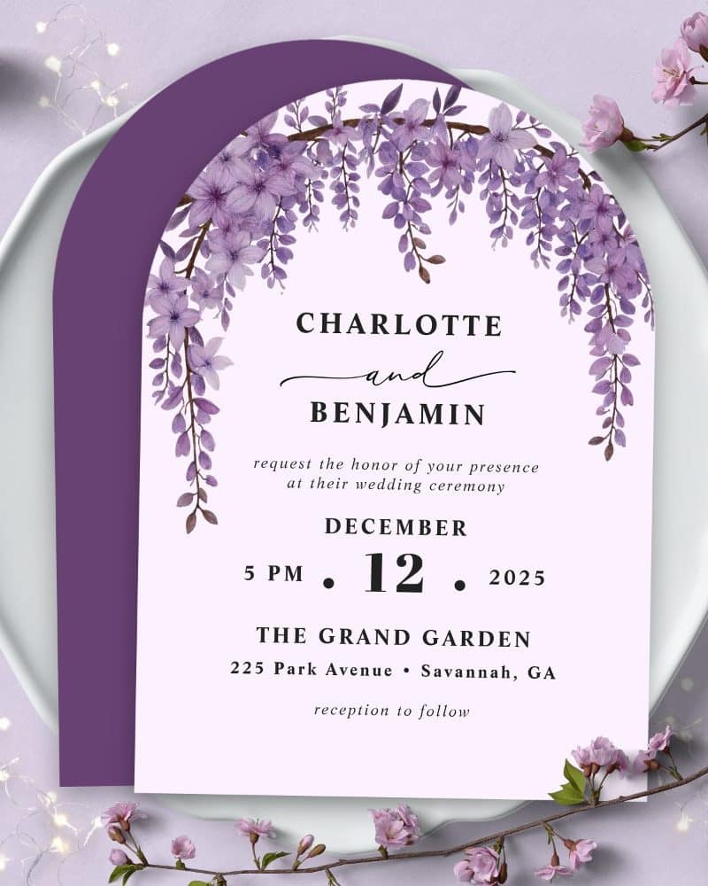 Wedding invitation for Charlotte and Benjamin, December 12, 2025, at The Grand Garden in Savannah, Georgia. Purple wisteria flowers adorn the arched design.