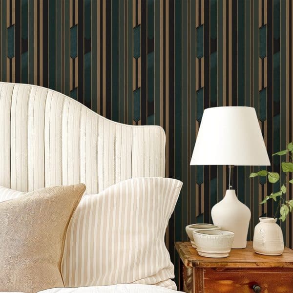 A Beige Striped Headboard With Matching Pillows Sits Against A Wall With Dark Teal And Gold Striped Wallpaper.
