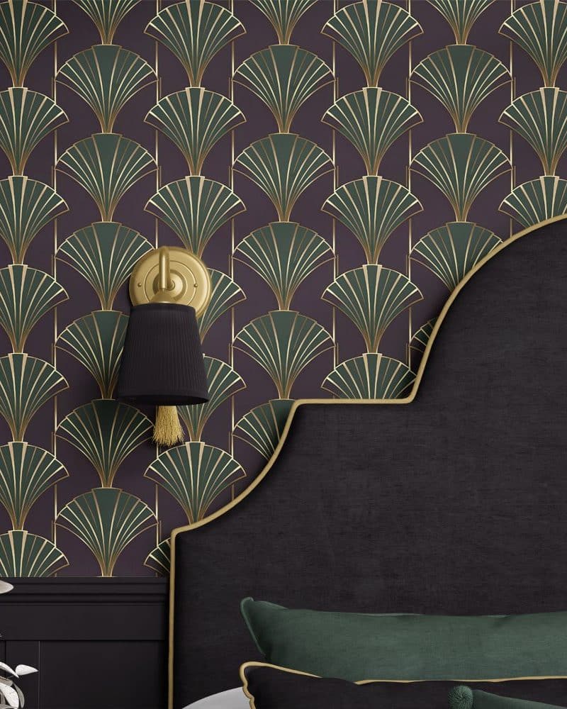 Dark purple Art Deco wallpaper with gold and green accents featuring a repeating fan pattern, partially visible behind a dark headboard.