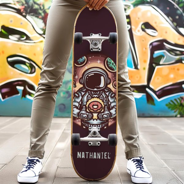 Person Holding Skateboard Featuring An Astronaut Holding A Donut In Space.