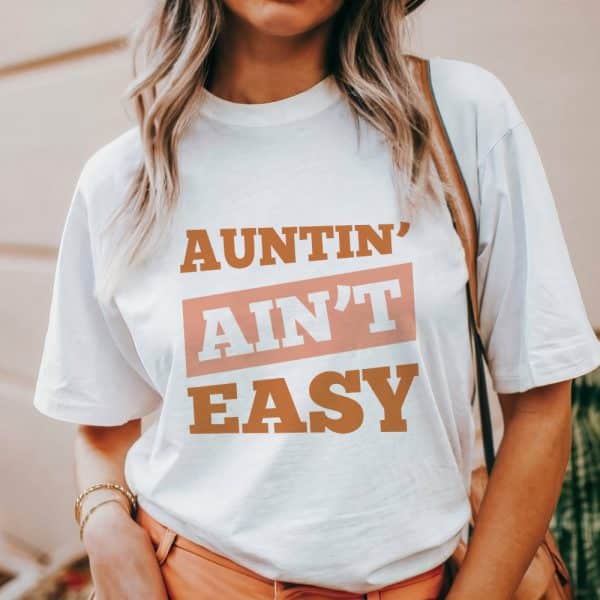 Woman Wearing A White T-Shirt With The Text Auntin' Ain'T Easy.