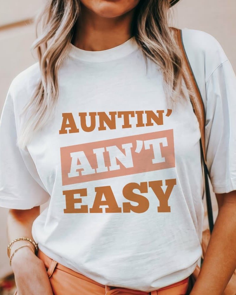 Woman wearing a white t-shirt with the text Auntin' Ain't Easy.