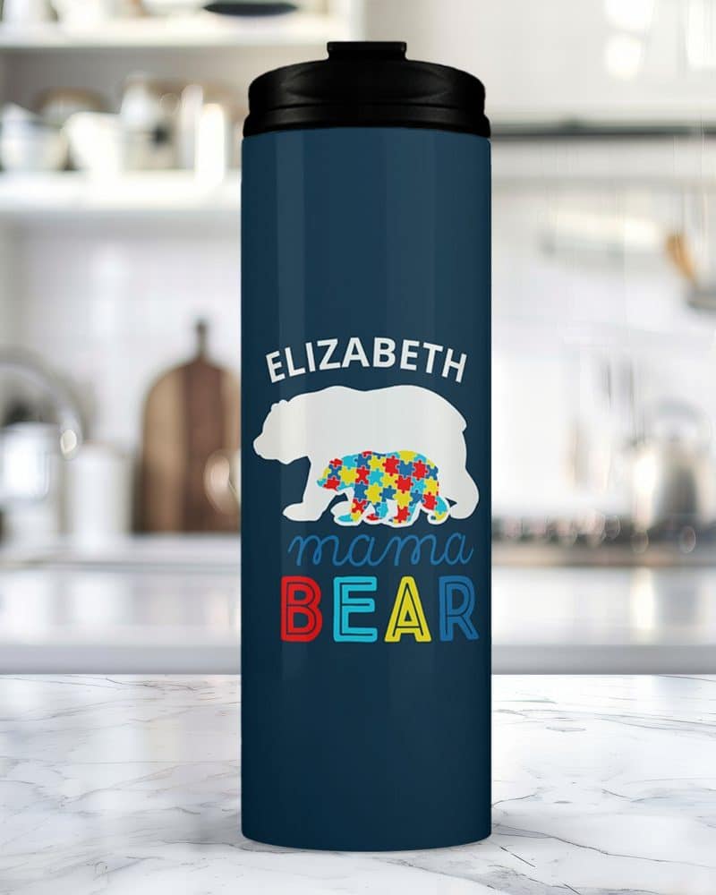 Dark blue travel mug with the name Elizabeth, two bears, and Mama Bear in colorful text. One bear is made of puzzle pieces.