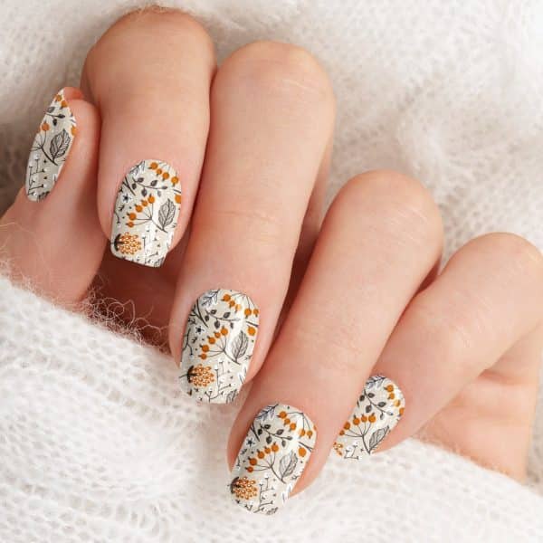 Close-Up Of A Hand With Fingernails Adorned With An Autumnal Floral Nail Design.
