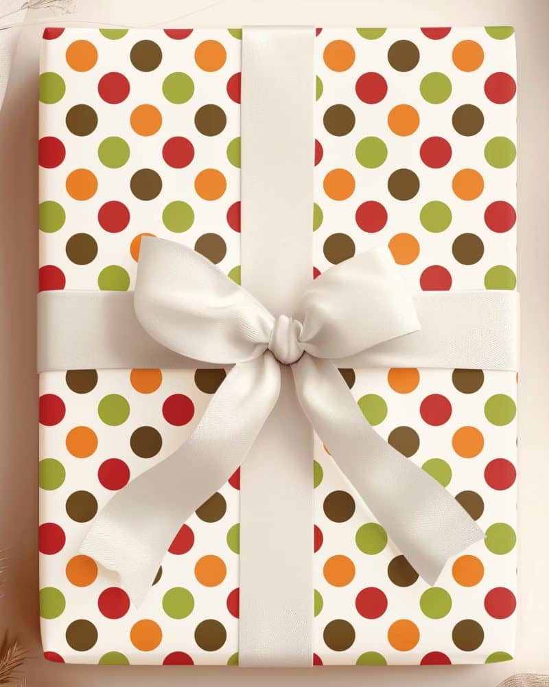 Gift wrapped in autumn-colored polka dot paper with a cream-colored ribbon.