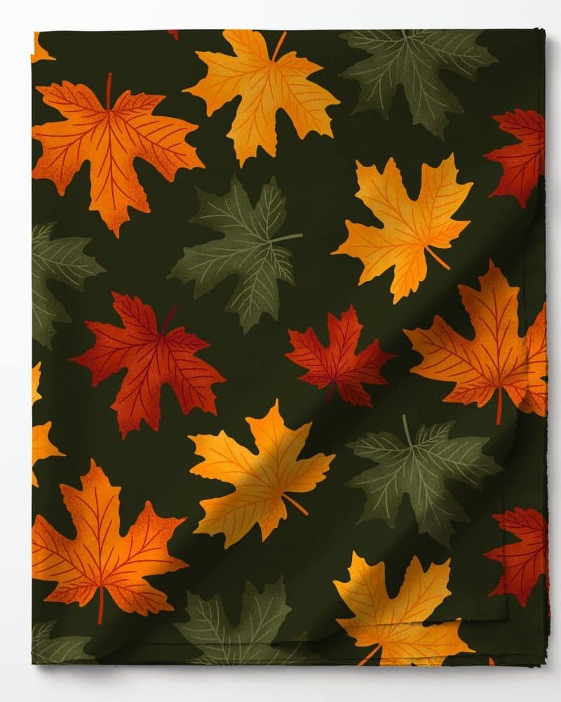 Dark green fabric with a repeating pattern of orange, red, and olive green maple leaves.