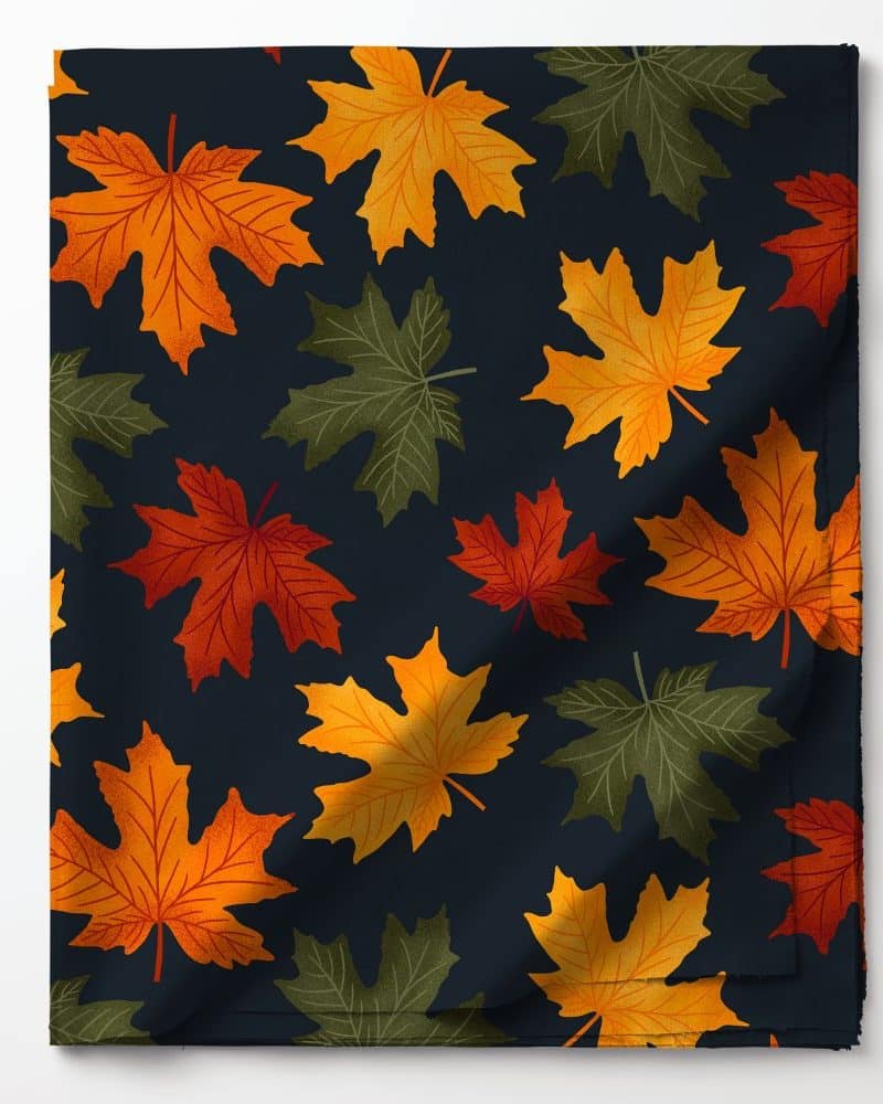 Dark fabric with a repeating pattern of orange, red, and green maple leaves.