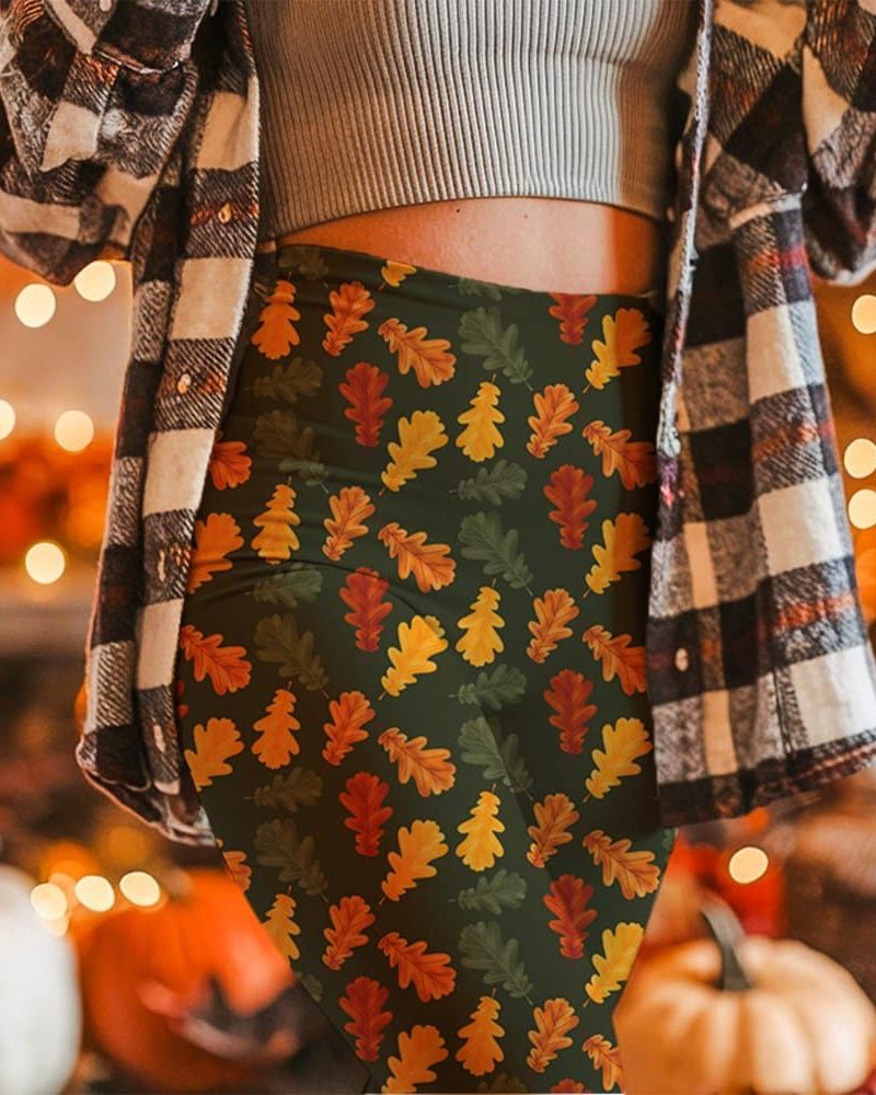 Woman wearing leggings with an autumn leaf pattern.