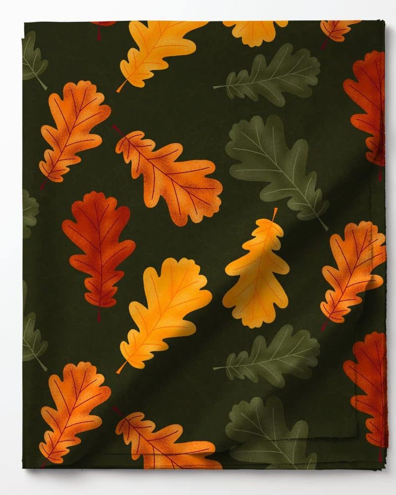 Dark green fabric with a repeating pattern of orange and green oak leaves.