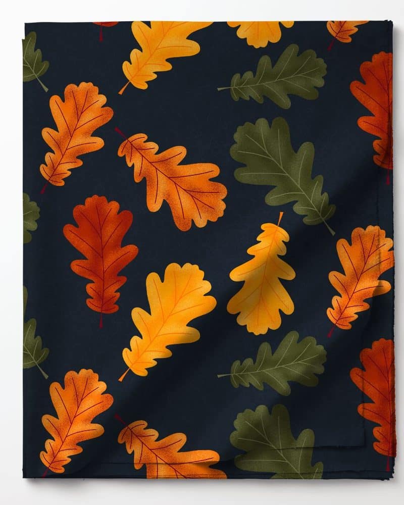 Dark blue fabric with a pattern of orange, gold, and green oak leaves.