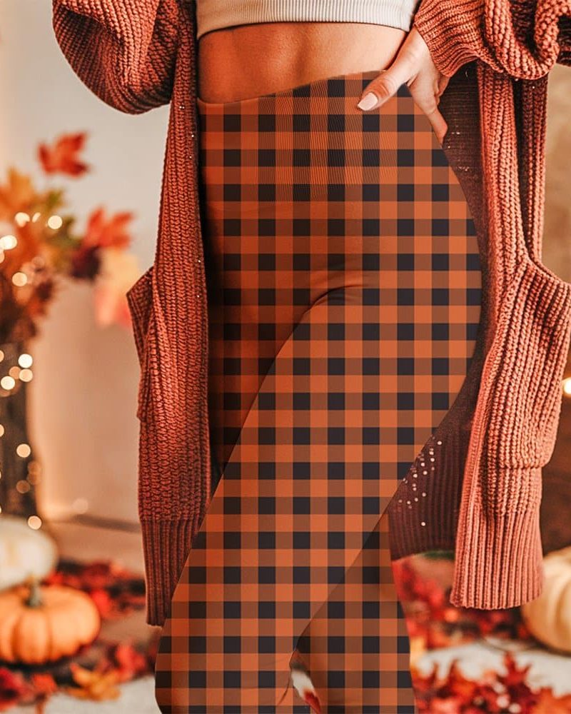 Close-up of a person wearing burnt orange and black buffalo plaid leggings.