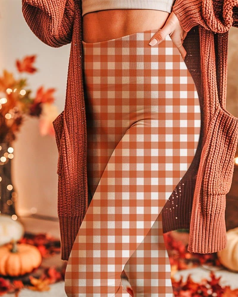 Woman wearing burnt orange and white gingham leggings.