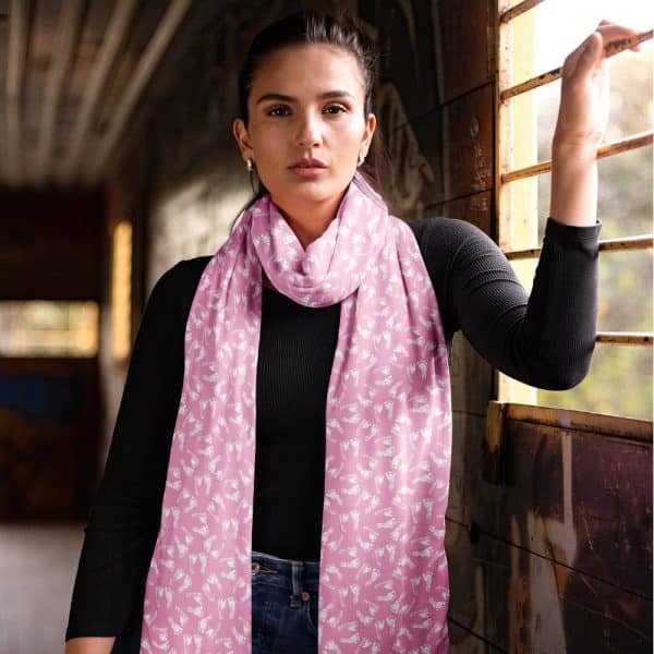Woman Wearing A Pink Scarf With A White Footprint Pattern.