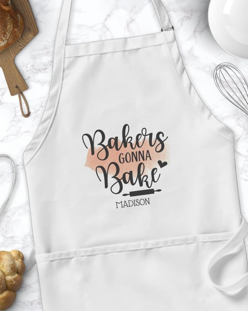 White bakers apron with the text Bakers Gonna Bake and the name Madison.