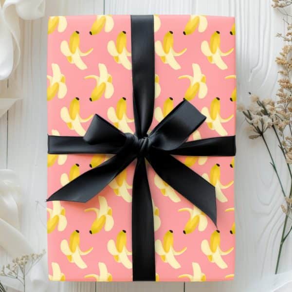 Pink Gift Box With A Black Ribbon, Wrapped In Banana Peel Pattern Paper.