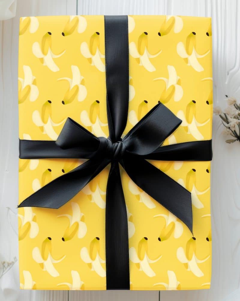 Yellow gift box with a banana peel pattern and black ribbon.