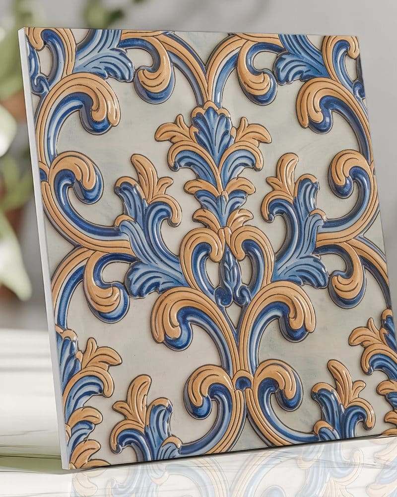 Ornate tile with blue and gold floral pattern.