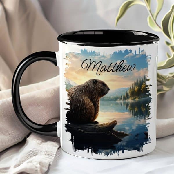 A Black-Handled Mug With A Personalized Design Features A Beaver Sitting On A Log By A Lake At Sunset, With The Name Matthew Printed On It.