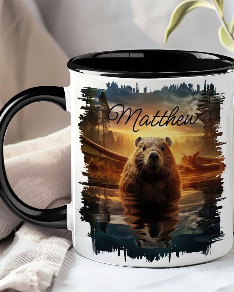 A black and white mug with a personalized name, Matthew, and a beaver in a sunset scene.