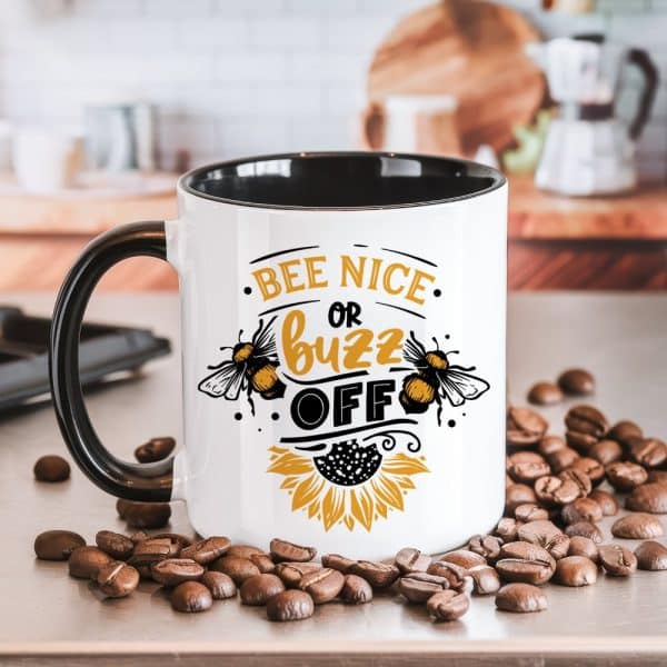 White Coffee Mug With Black Handle And Interior, Featuring A Bee-Themed Design And The Text Bee Nice Or Buzz Off.